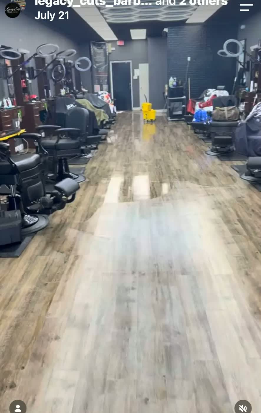 Inside Legacy Cuts Barbershop — barber chairs lining the shop floor under hex lighting